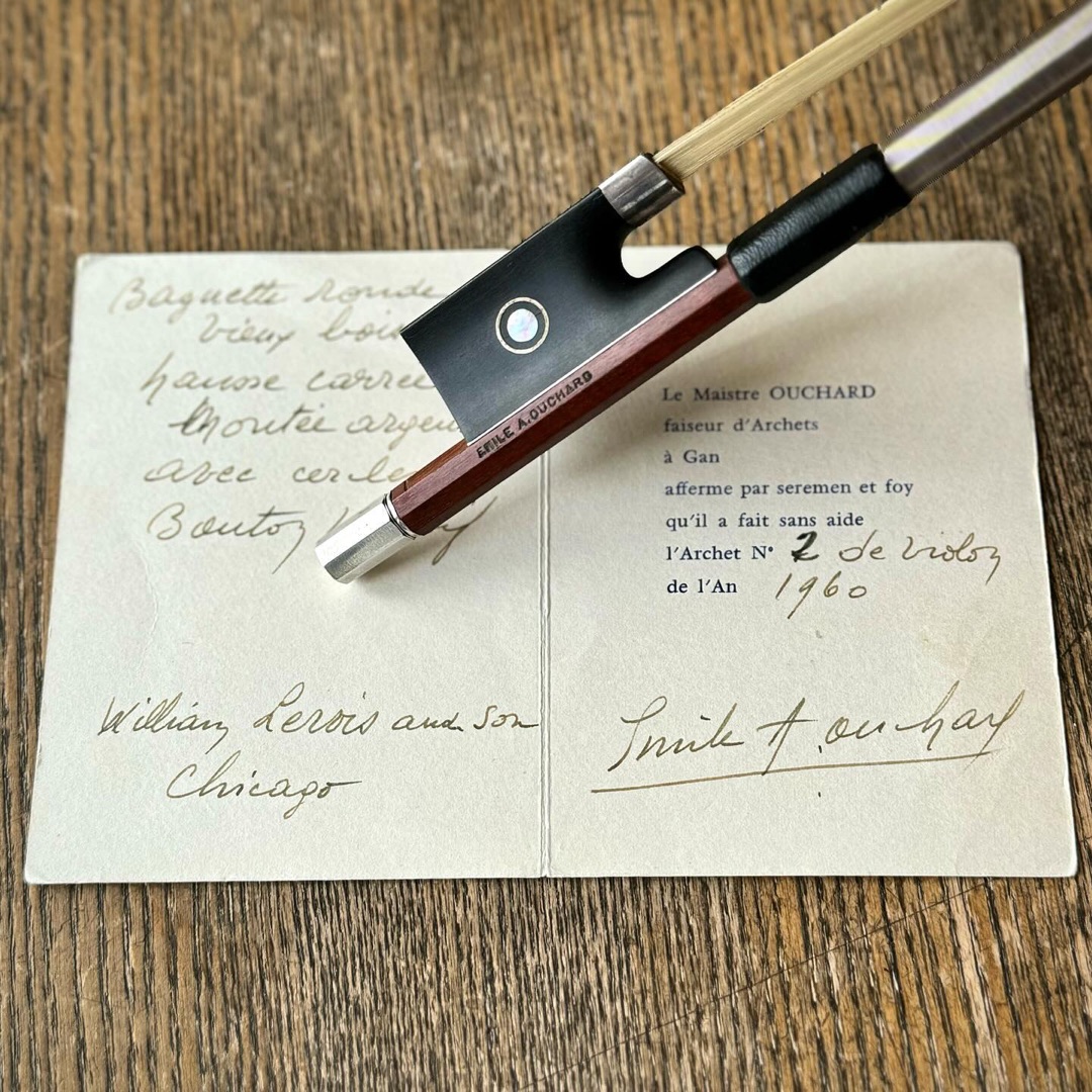 E. A. Ouchard violin bow resting on its original 1960 certificate